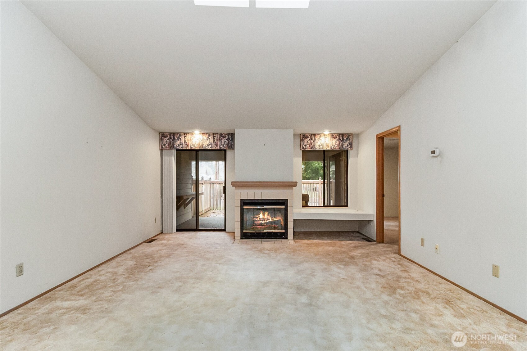 1310 Boise Street Fircrest, WA 98466 - Photo 22 of 36 an empty room with a fireplace and painted walls