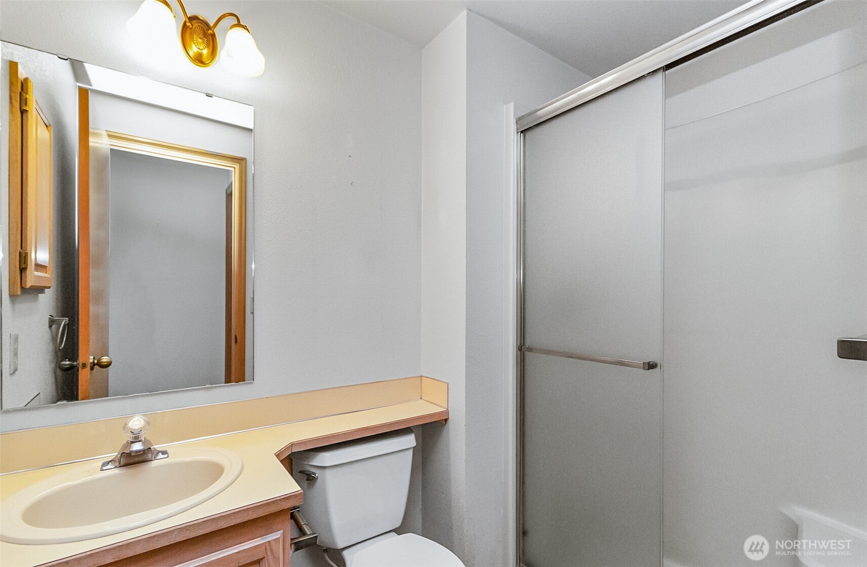 1310 Boise Street Fircrest, WA 98466 - Photo 23 of 36 a bathroom with a sink a toilet and mirror