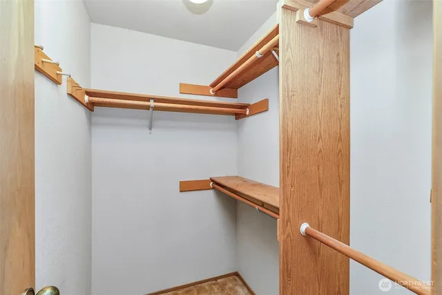a bathroom with a sink double vanity granite tub and a mirror