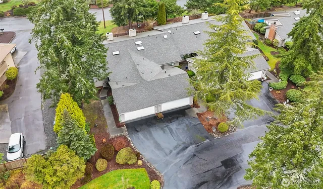 an aerial view of residential house with swimming pool and lawn chairs
