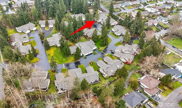 an aerial view of a residential houses with yard