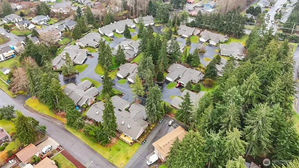 an aerial view of residential house with swimming pool and lawn chairs