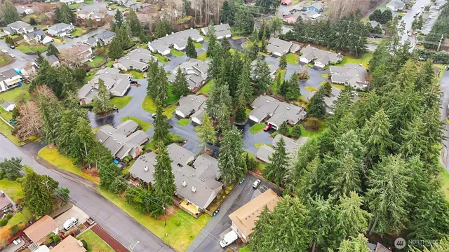 an aerial view of residential house with swimming pool and lawn chairs