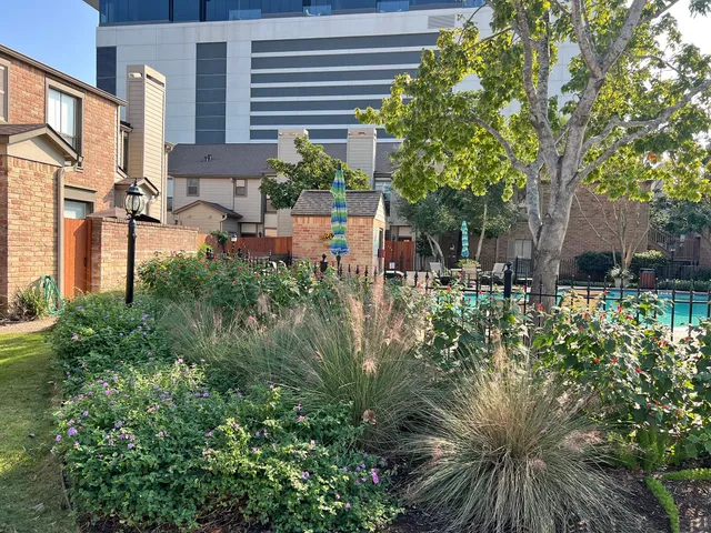 a view of backyard of house with outdoor seating and green space