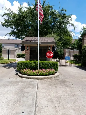 a view of a house with a yard and potted plants