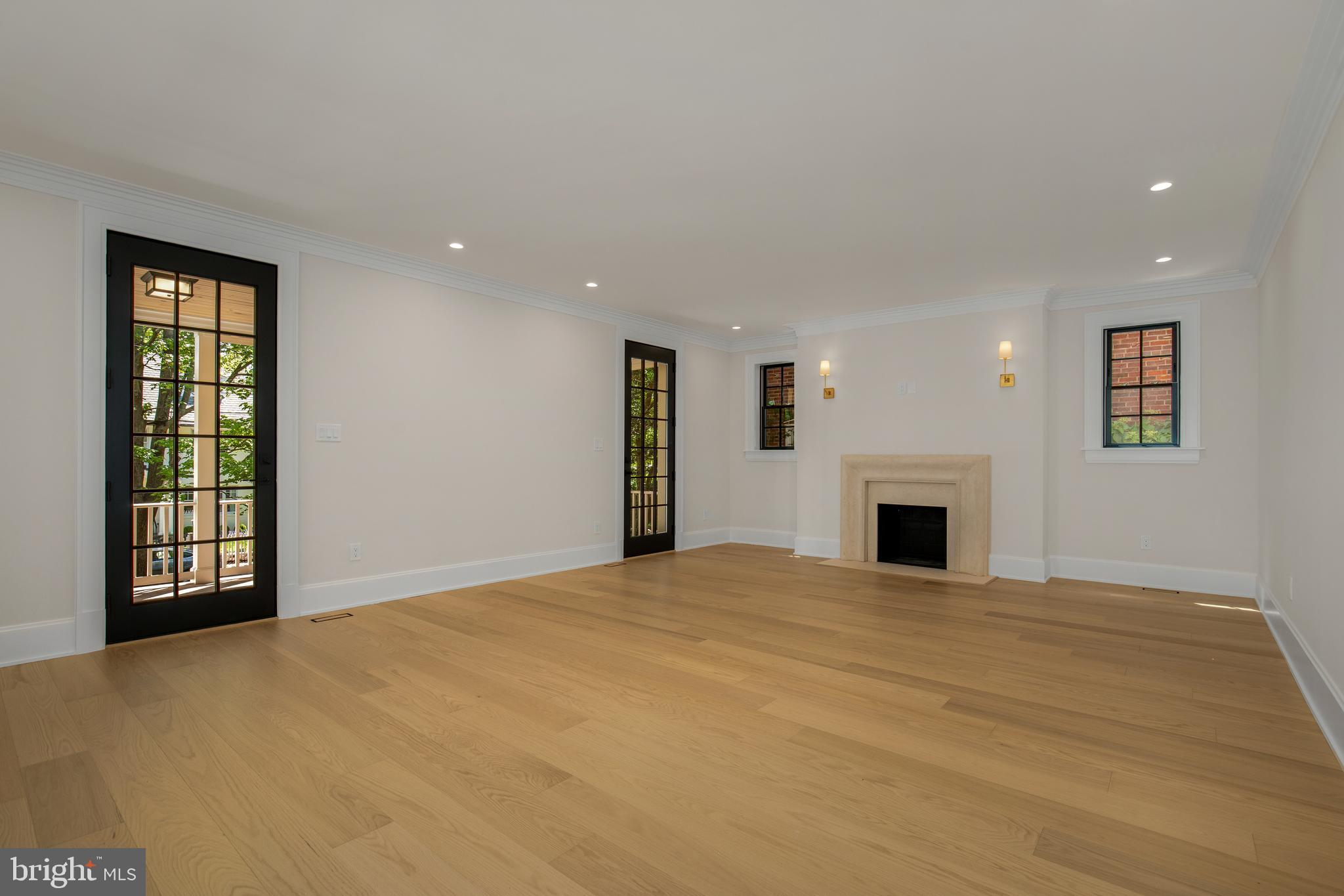 2710 36th Street Northwest Washington, DC 20007 - Photo 7 of 29 a view of an empty room with a fireplace and a window