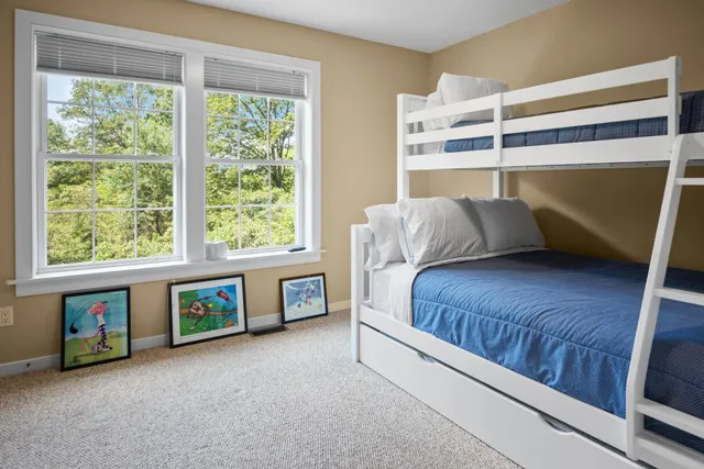 a bedroom with a bed and a large window