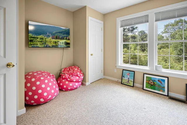 a bedroom with furniture and a large window