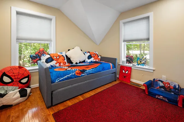 a bedroom with baby toys and dresser