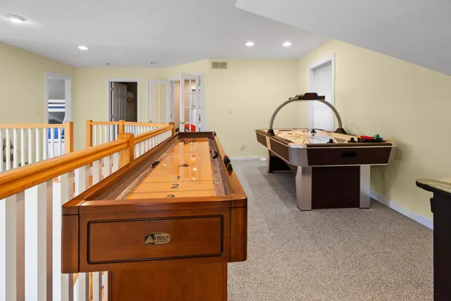 a living room with furniture a rug and a wooden floor