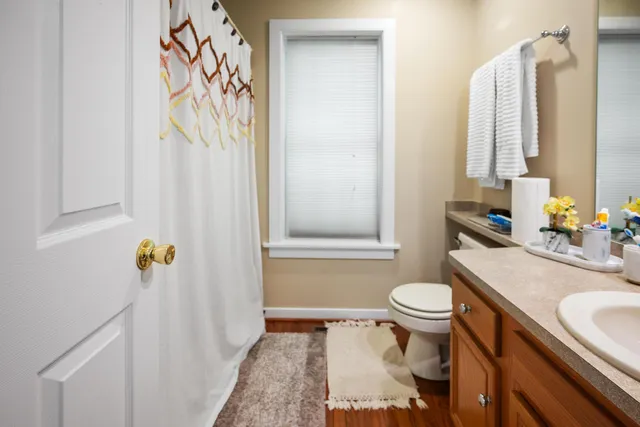 a bathroom with a sink toilet and shower