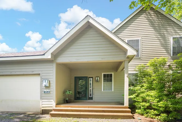 a view of a house with potted plants