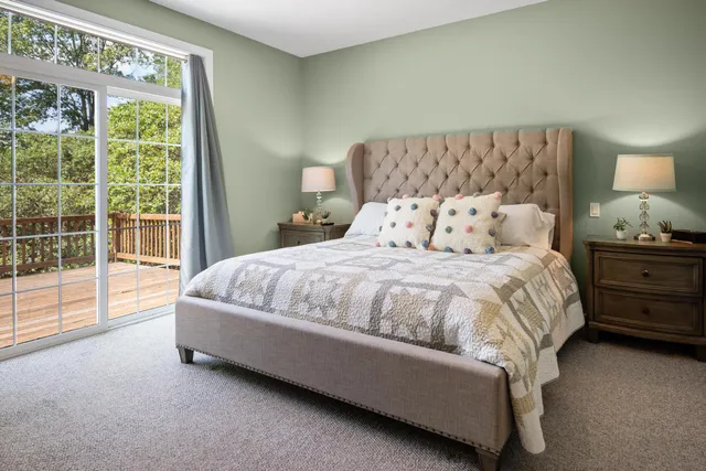 a bed sitting in a bedroom next to a window