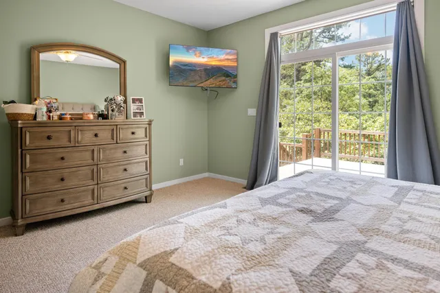 a bedroom with a bed and a mirror