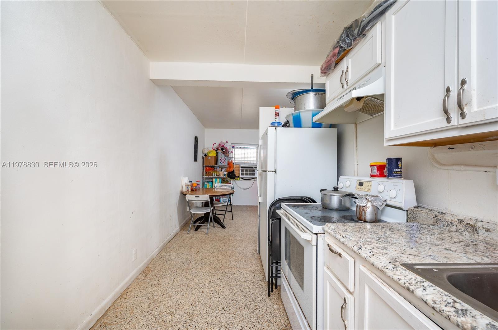 1101 Southwest 2nd Street Homestead, FL 33030 - Photo 13 of 17 a kitchen with refrigerator and cabinets