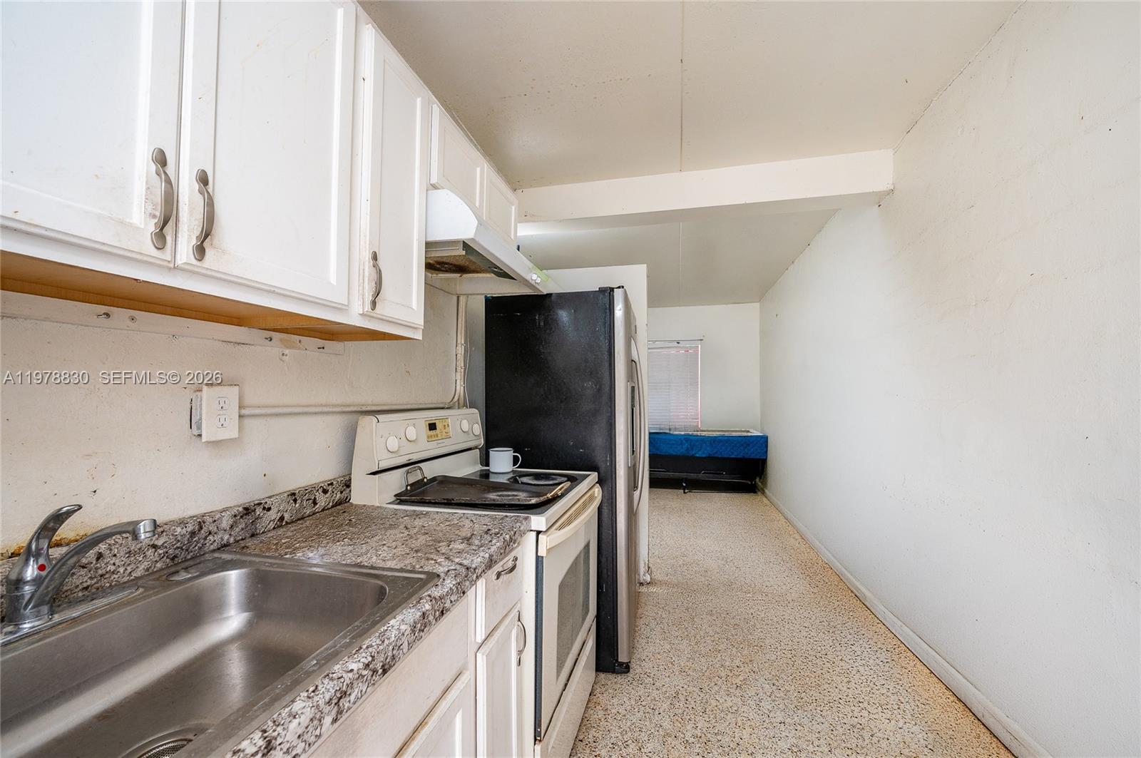 1101 Southwest 2nd Street Homestead, FL 33030 - Photo 15 of 17 a kitchen with a sink and a refrigerator