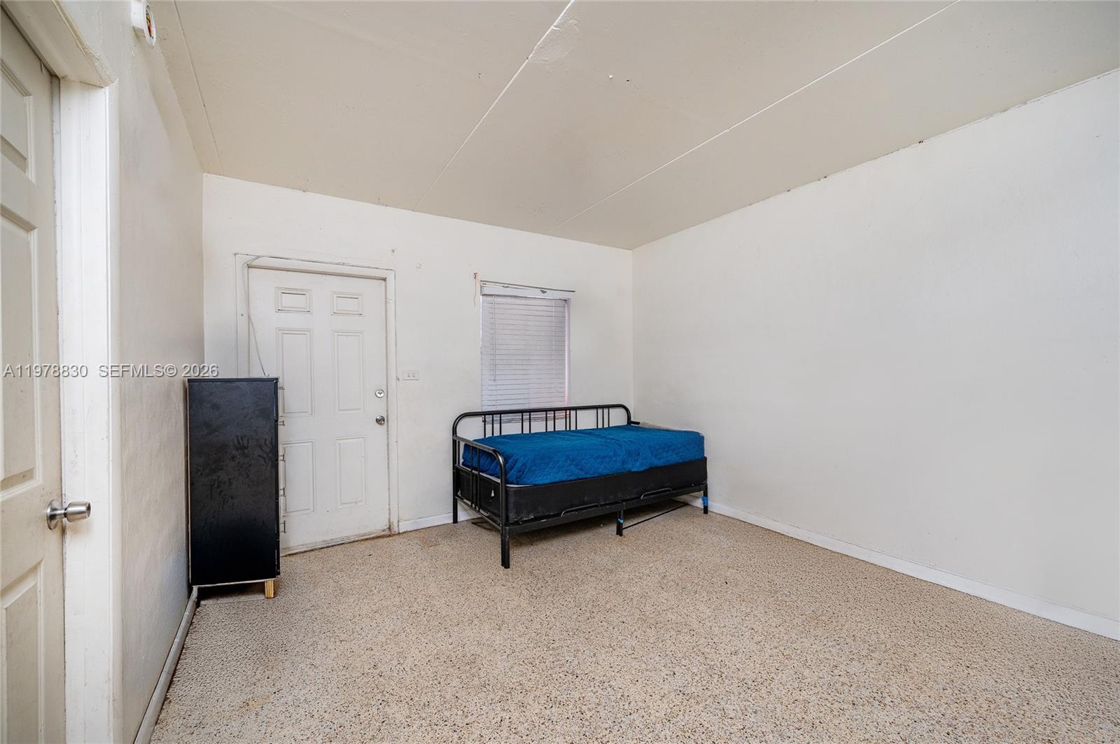 1101 Southwest 2nd Street Homestead, FL 33030 - Photo 16 of 17 a room with a bed and a table