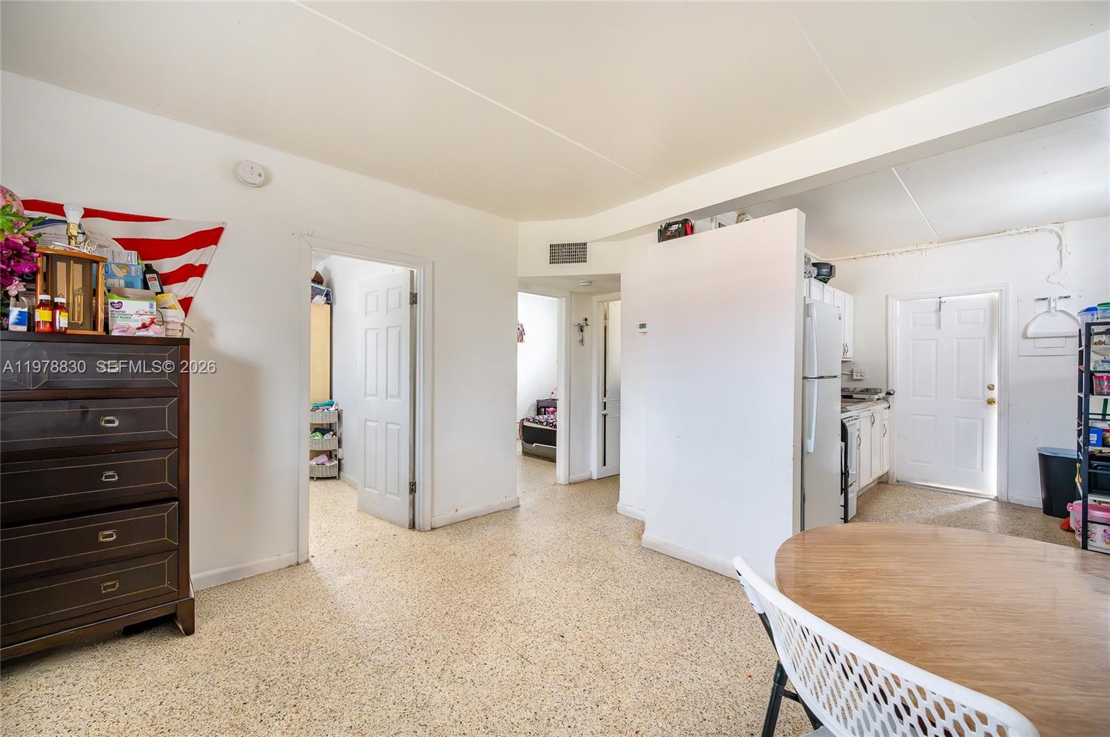 1101 Southwest 2nd Street Homestead, FL 33030 - Photo 7 of 17 a living room with furniture and a refrigerator