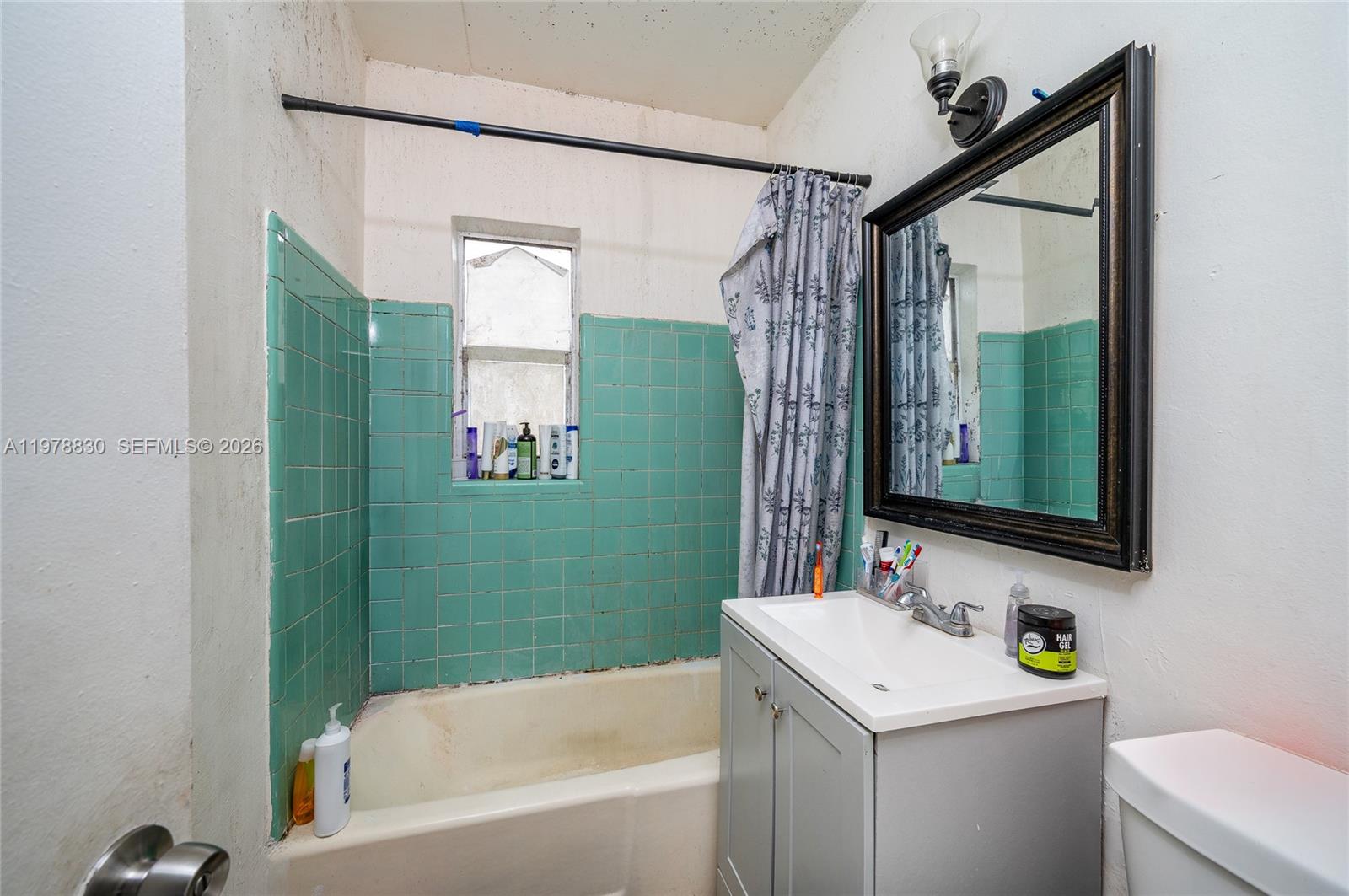 1101 Southwest 2nd Street Homestead, FL 33030 - Photo 9 of 17 a bathroom with a sink mirror toilet and bathtub