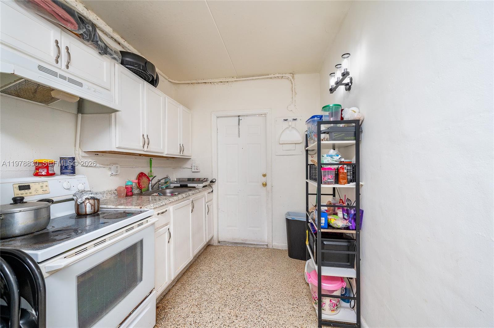 1101 Southwest 2nd Street Homestead, FL 33030 - Photo 10 of 17 a kitchen with a refrigerator and cabinets