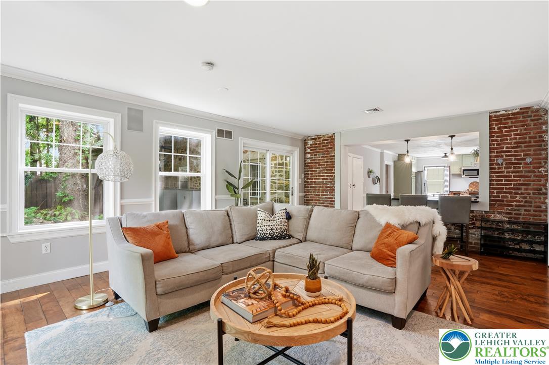 2014 Linden Street Bethlehem, PA 18017 - Photo 30 of 85 Rich hardwood floors complement an exposed brick accent wall, creating a cozy living space.