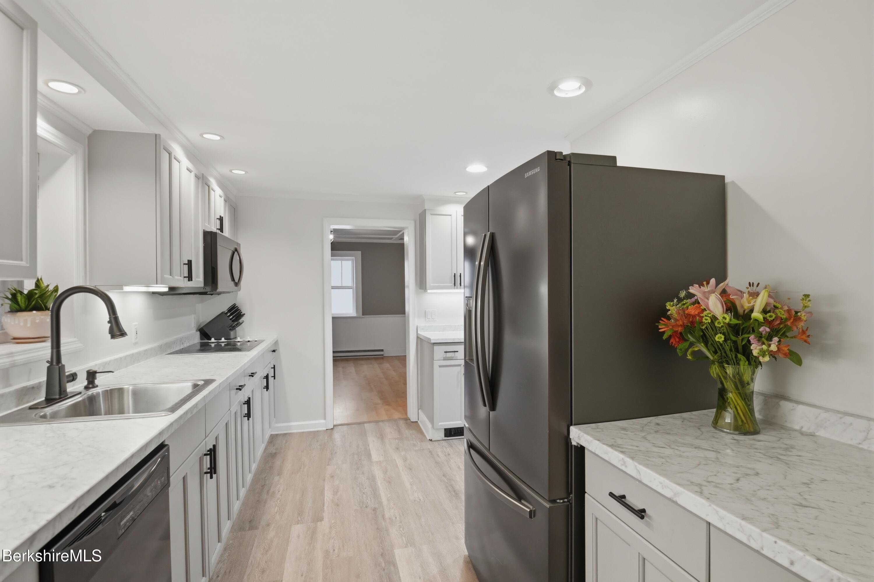 117 Norfolk Road New Marlborough, MA 01259 - Photo 11 of 59 a kitchen with stainless steel appliances granite countertop a refrigerator a sink a stove and cabinets