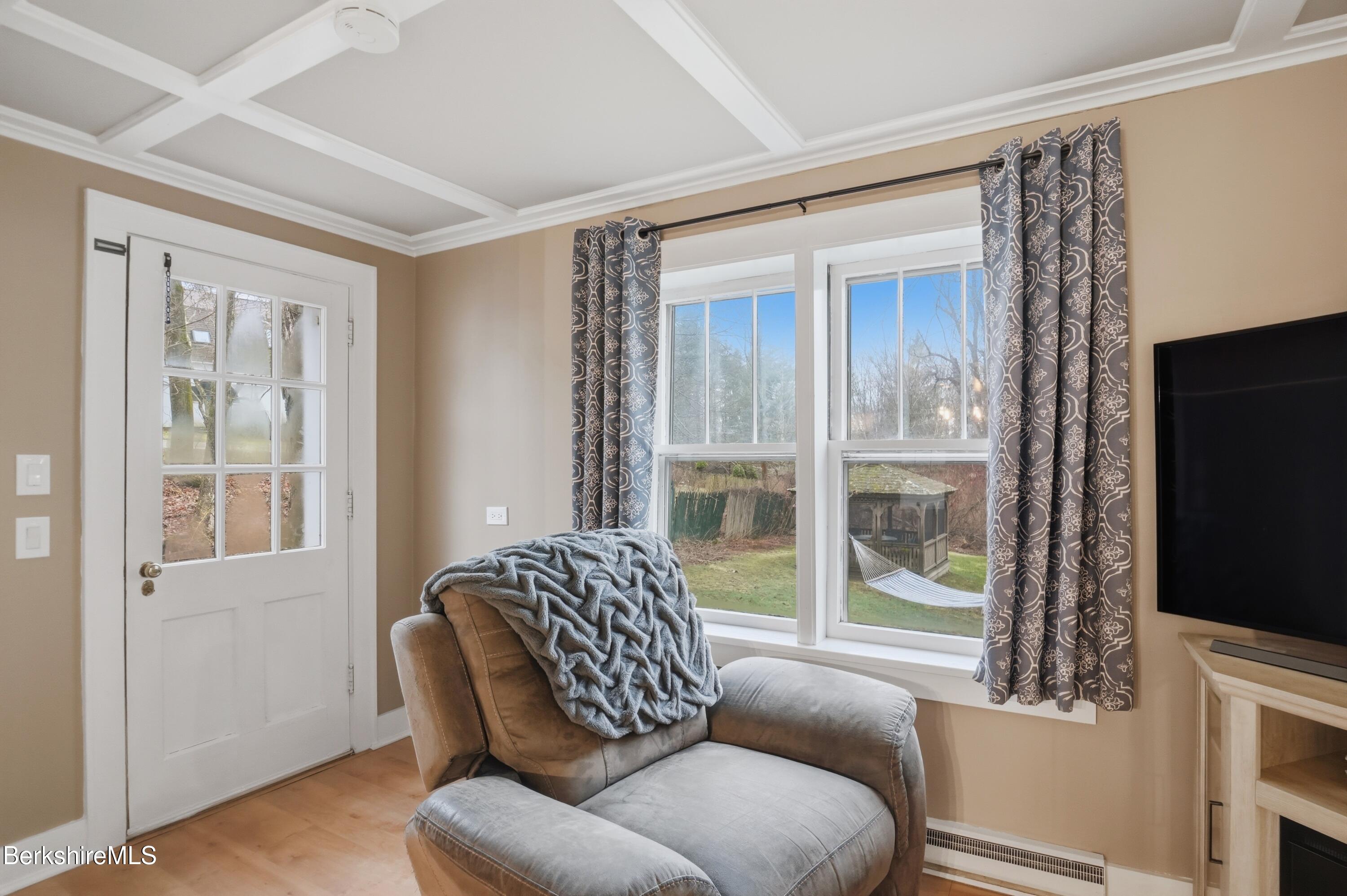 117 Norfolk Road New Marlborough, MA 01259 - Photo 16 of 59 a living room with furniture a flat screen tv and a floor to ceiling window