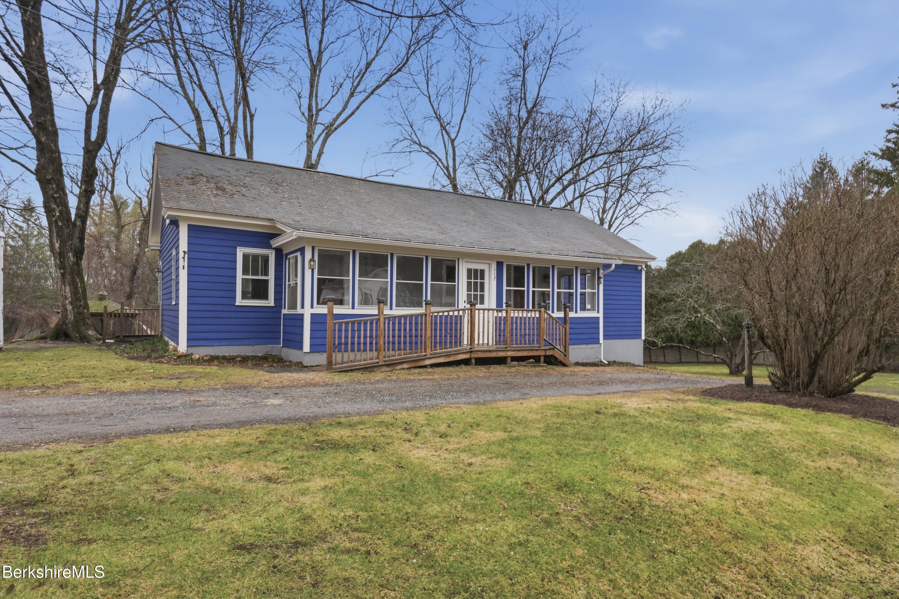 117 Norfolk Road New Marlborough, MA 01259 - Photo 2 of 59 a view of a brick house with a large windows and large trees