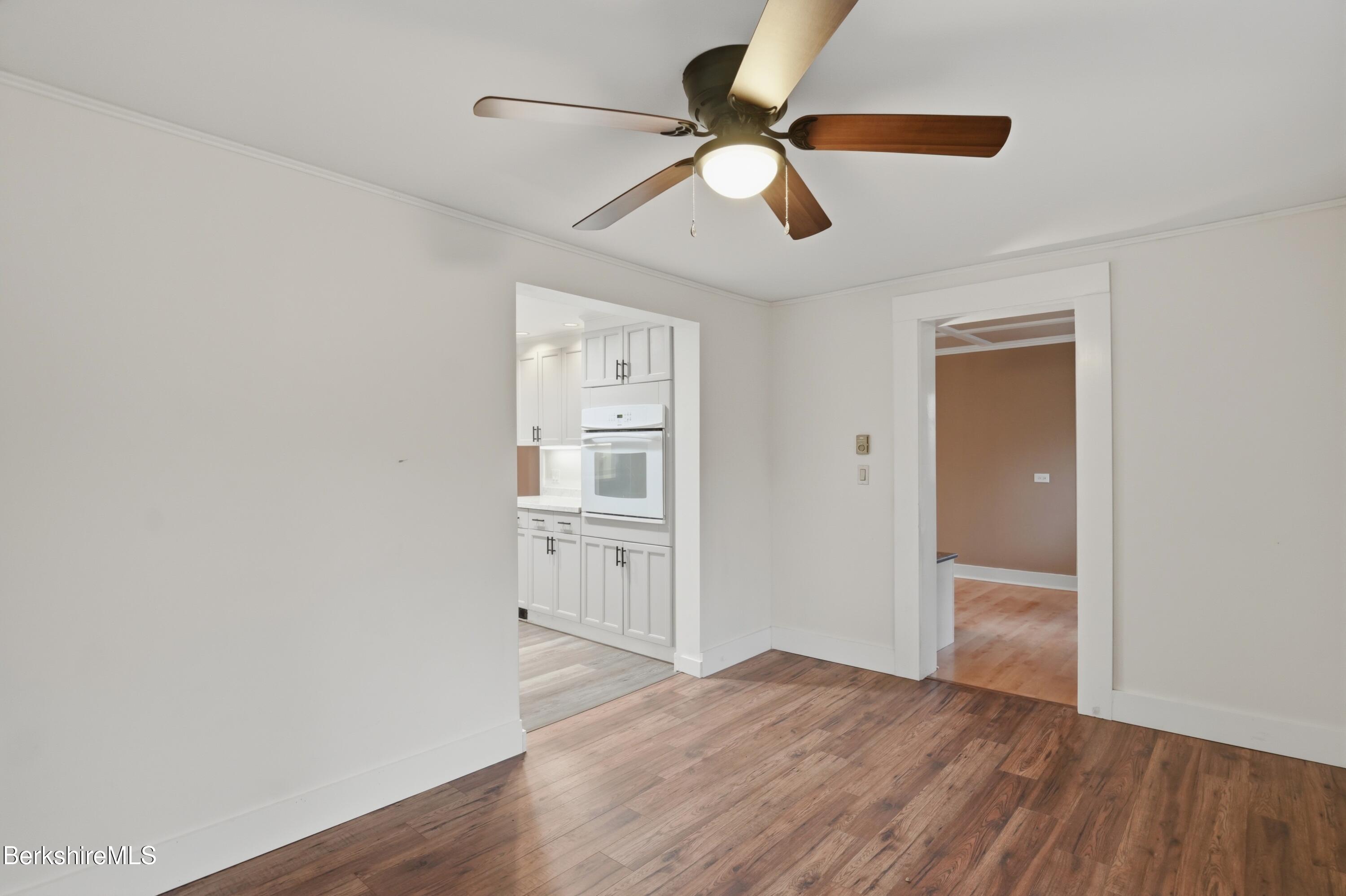 117 Norfolk Road New Marlborough, MA 01259 - Photo 24 of 59 an empty room with wooden floor fan and windows
