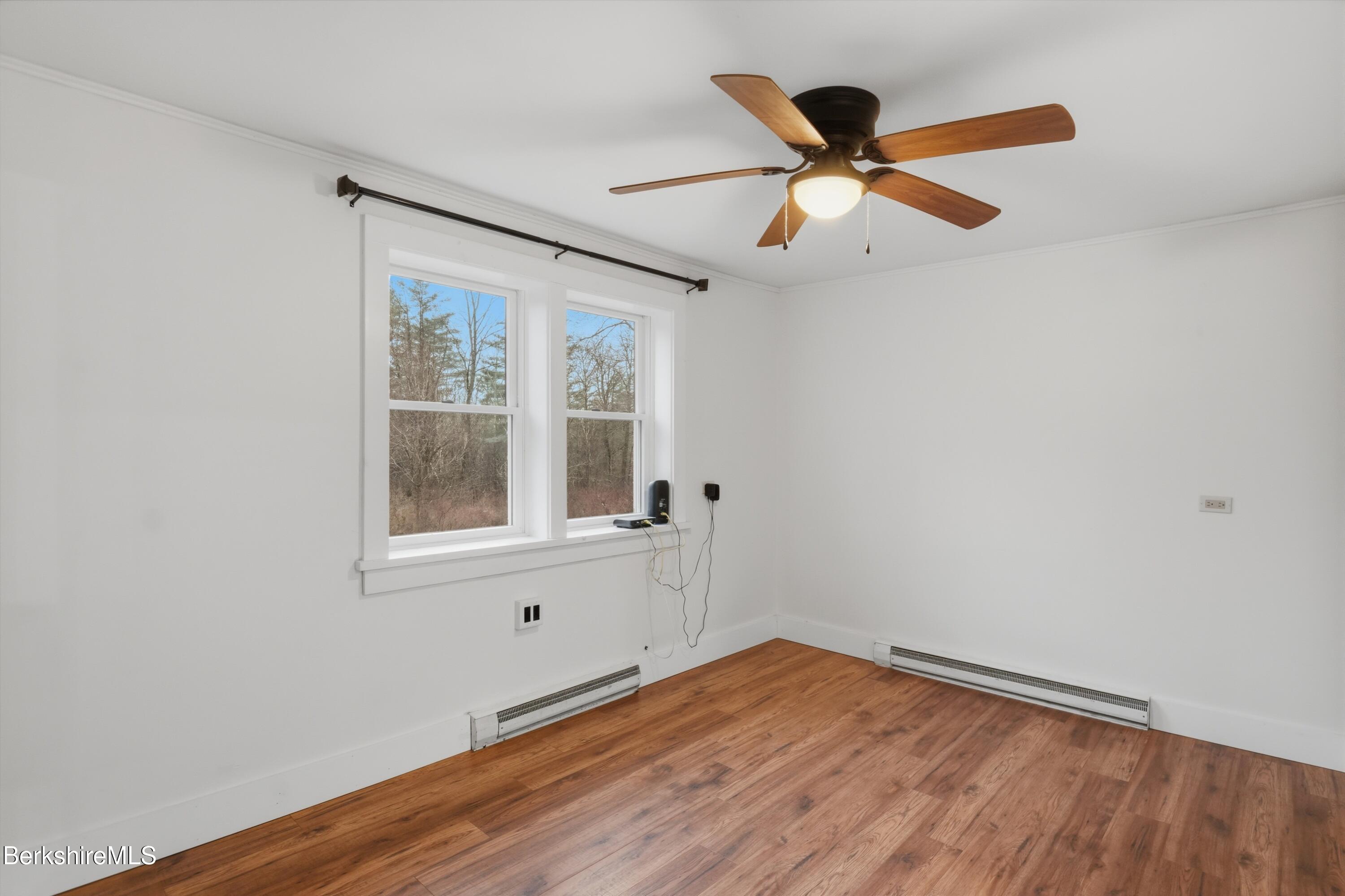 117 Norfolk Road New Marlborough, MA 01259 - Photo 27 of 59 an empty room with wooden floor fan and windows