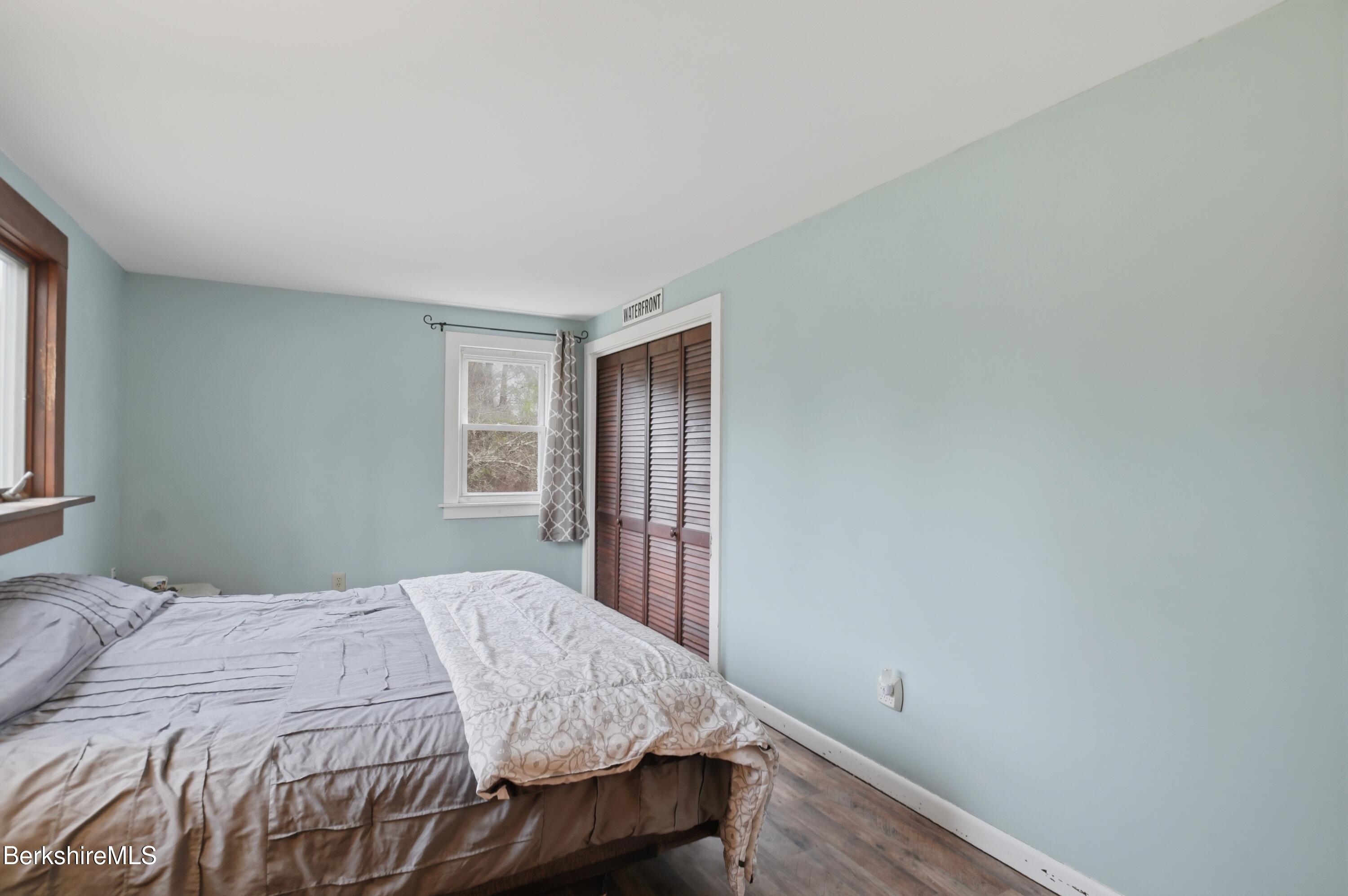 117 Norfolk Road New Marlborough, MA 01259 - Photo 30 of 59 a bedroom with a bed and wooden floor