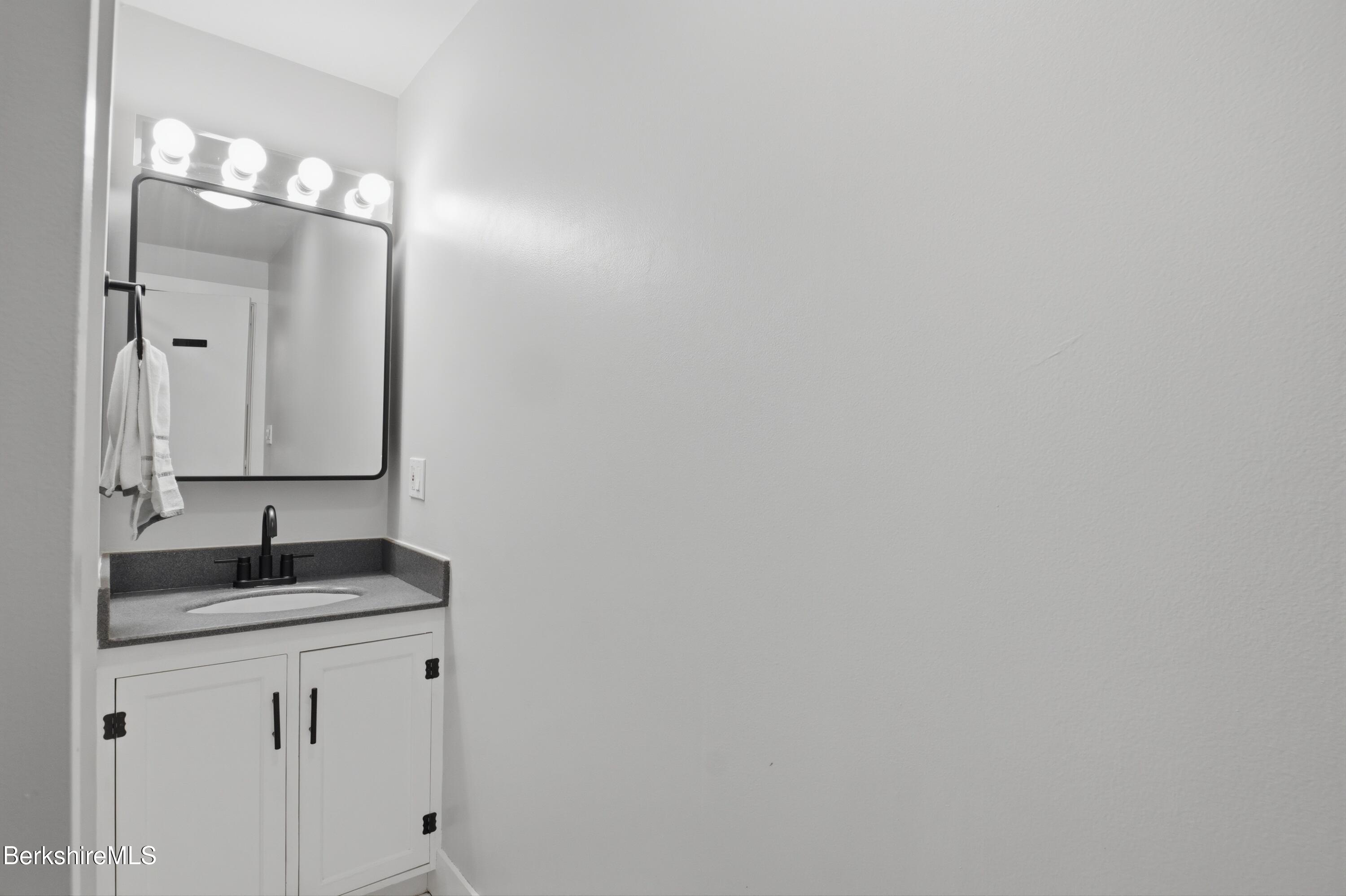 117 Norfolk Road New Marlborough, MA 01259 - Photo 41 of 59 a bathroom with a sink and a mirror