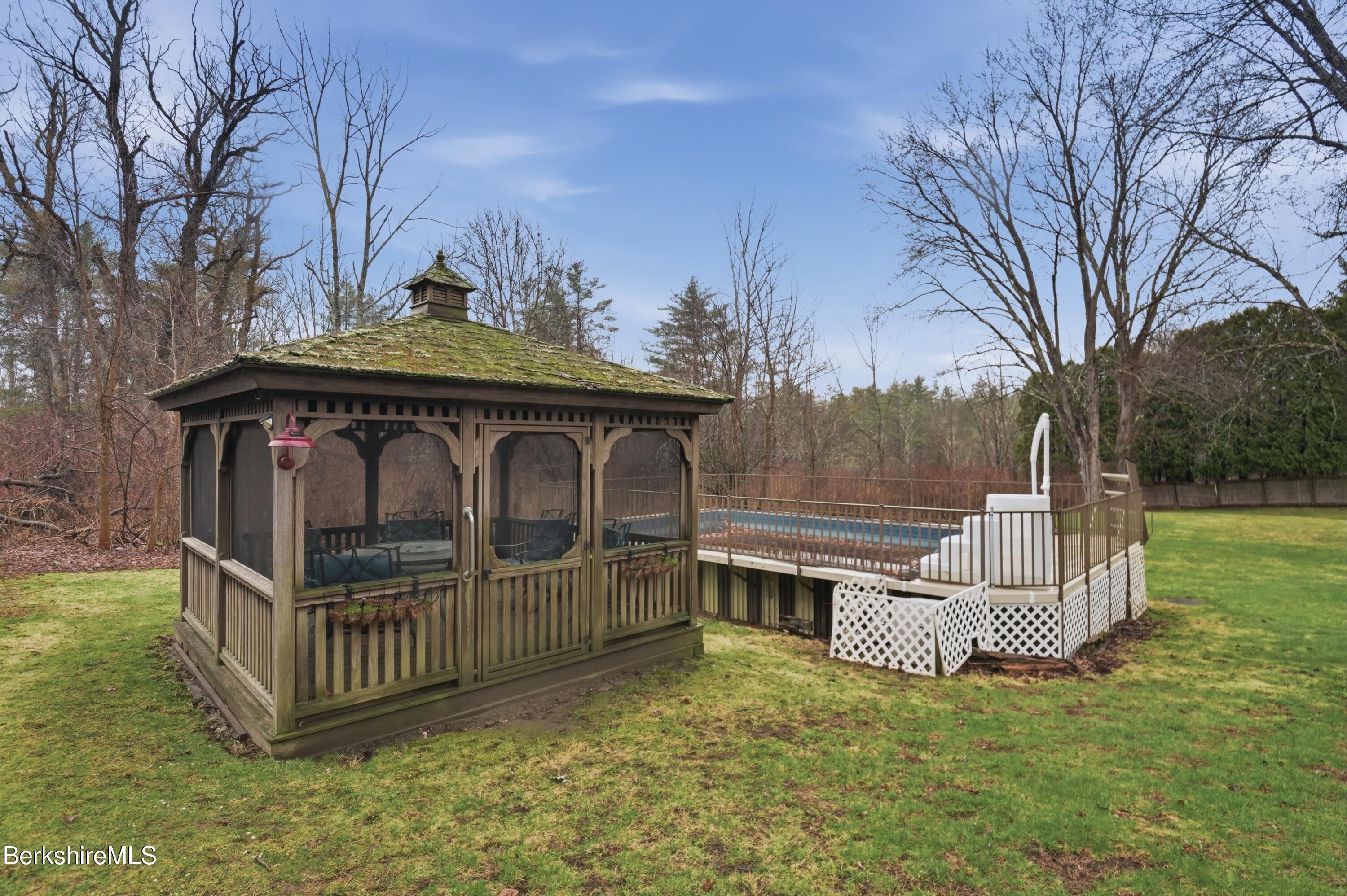 117 Norfolk Road New Marlborough, MA 01259 - Photo 46 of 59 a view of a deck with a bench and trees