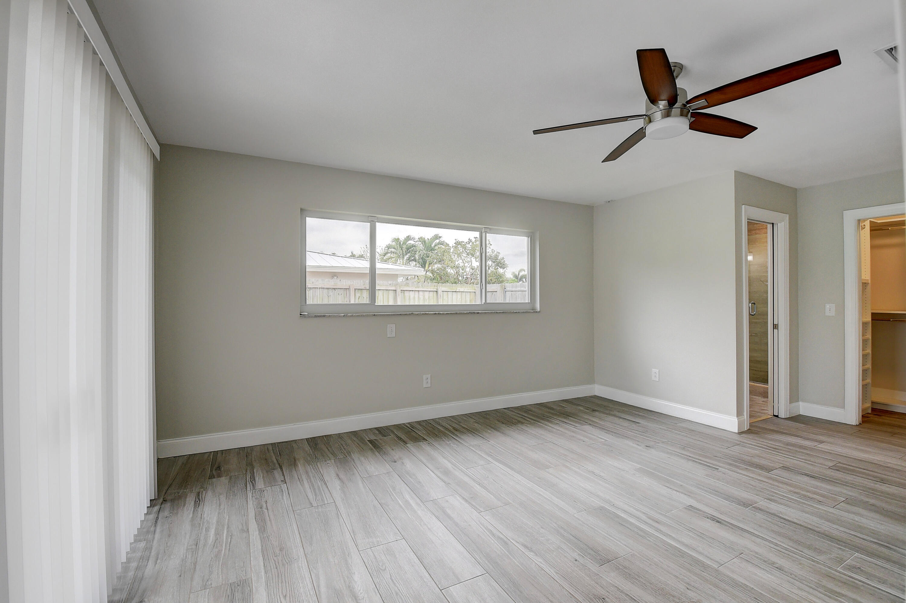 798 Southwest 15th Avenue Boca Raton, FL 33486 - Photo 12 of 27 a view of an empty room with wooden floor and a window