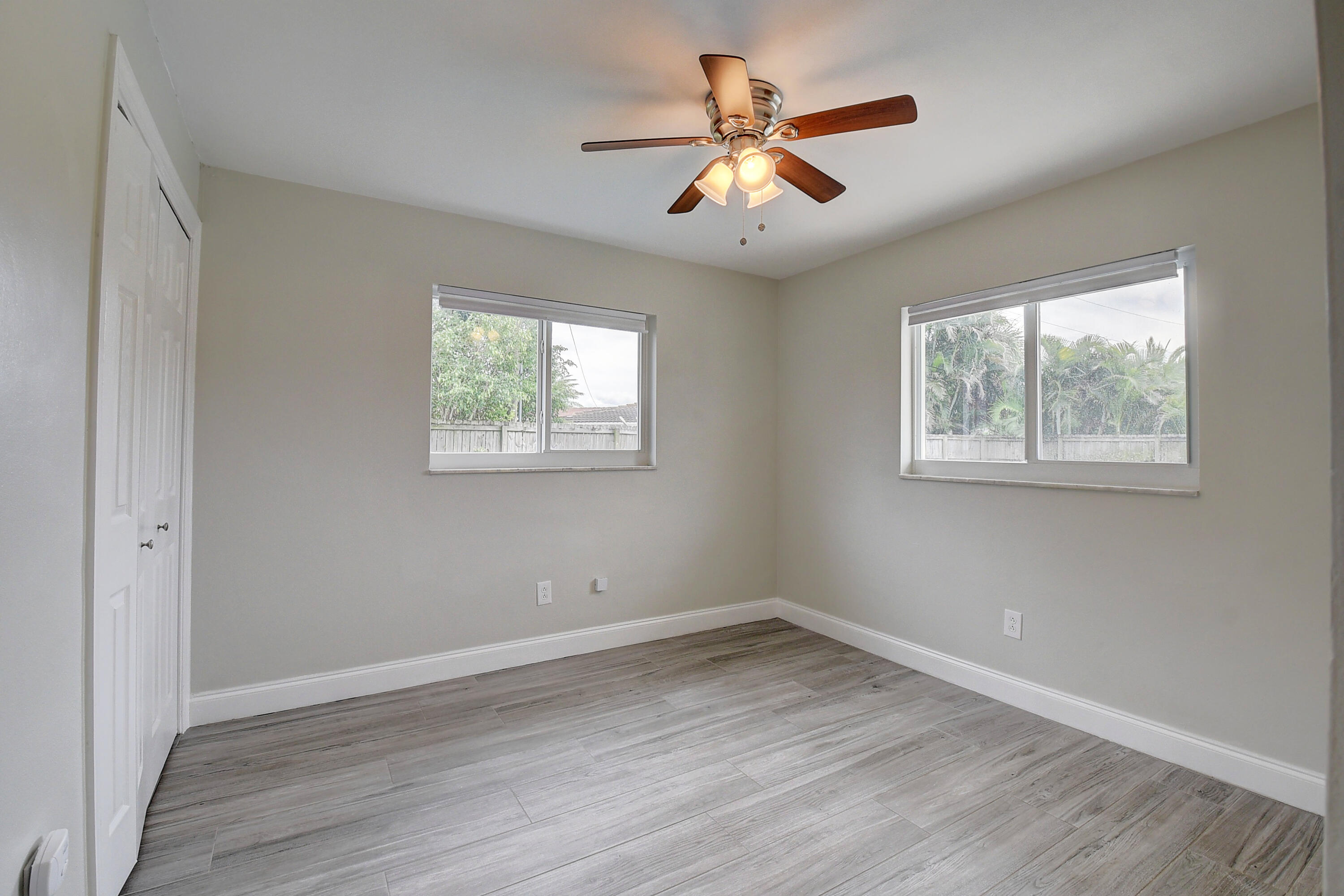 798 Southwest 15th Avenue Boca Raton, FL 33486 - Photo 17 of 27 a view of a big room with wooden floor and windows