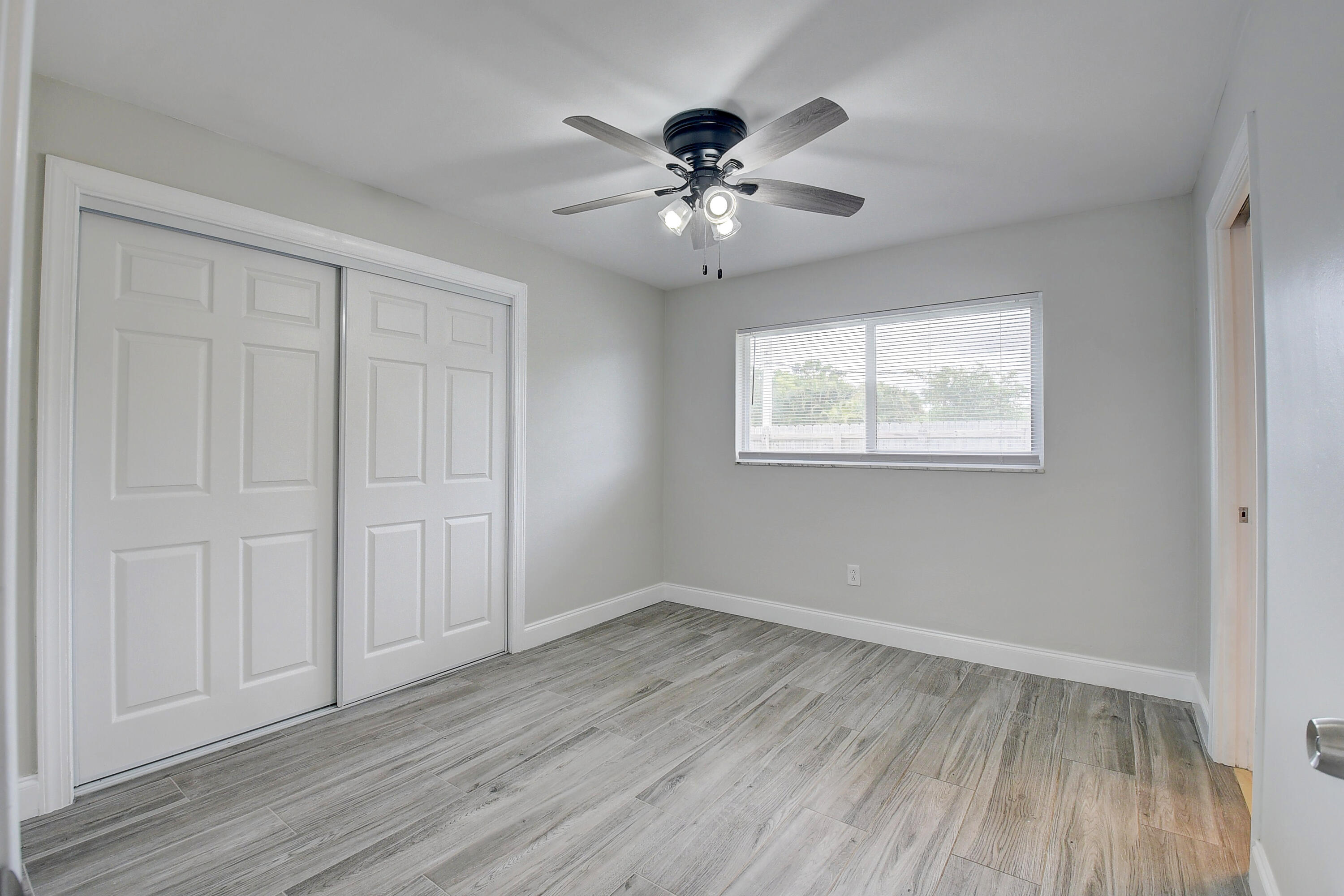 798 Southwest 15th Avenue Boca Raton, FL 33486 - Photo 22 of 27 a view of an empty room with wooden floor and a window