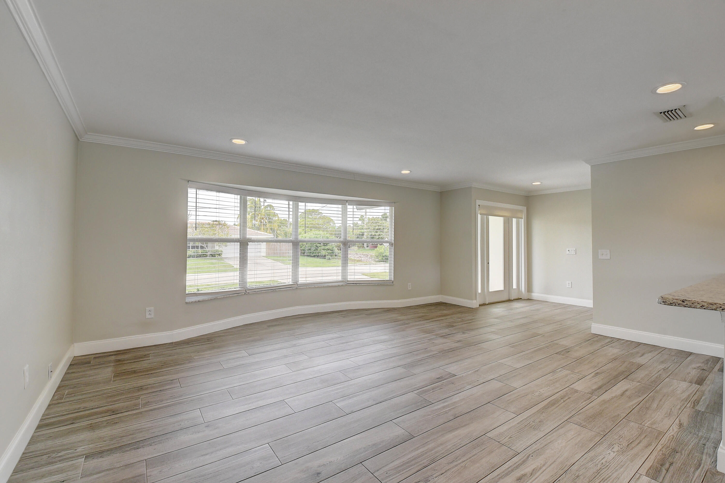 798 Southwest 15th Avenue Boca Raton, FL 33486 - Photo 5 of 27 an empty room with wooden floor and windows