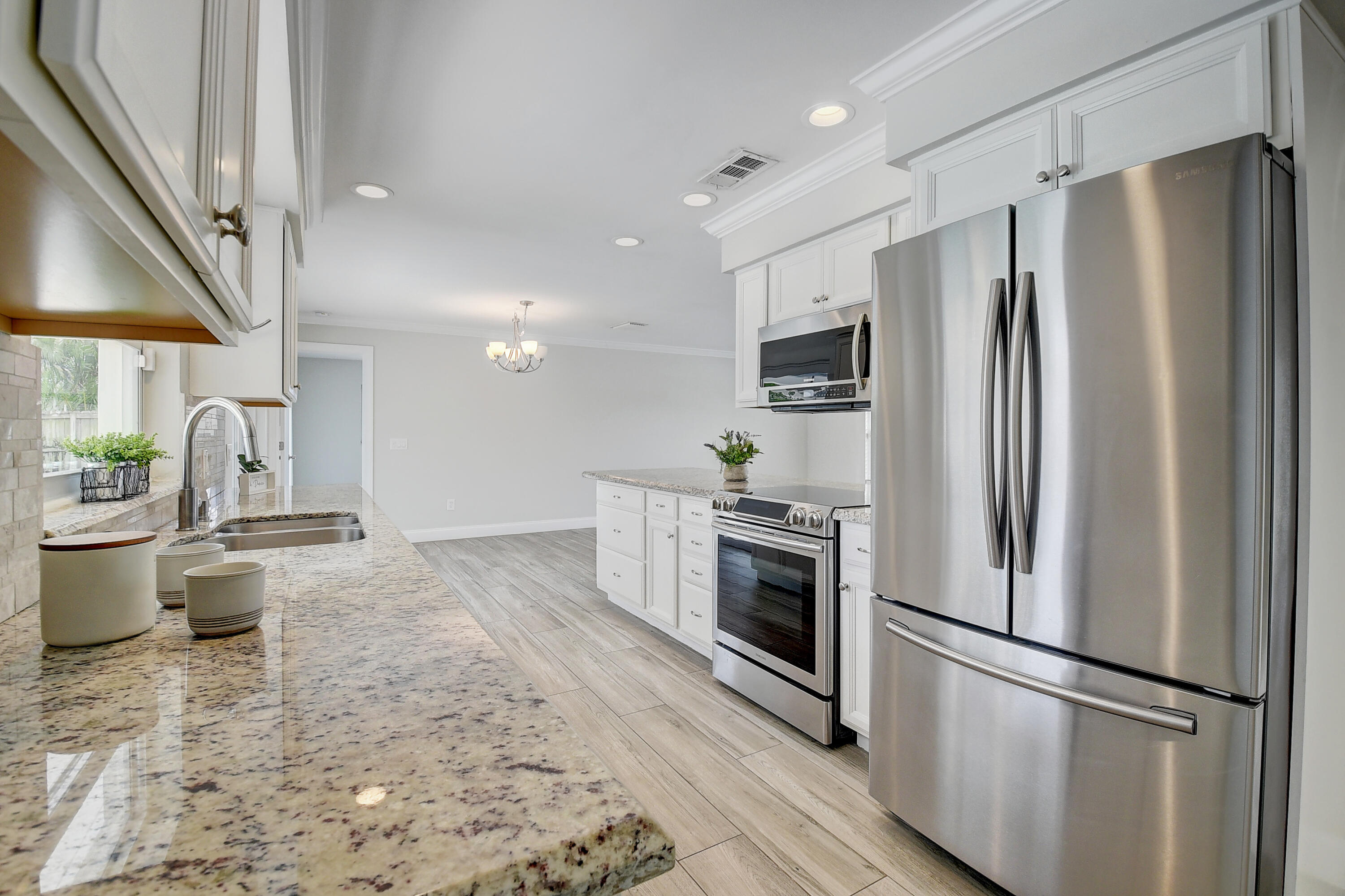 798 Southwest 15th Avenue Boca Raton, FL 33486 - Photo 9 of 27 a kitchen with stainless steel appliances a refrigerator sink and stove