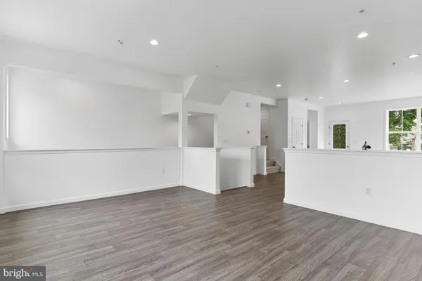 a view of a kitchen with wooden floor and windows