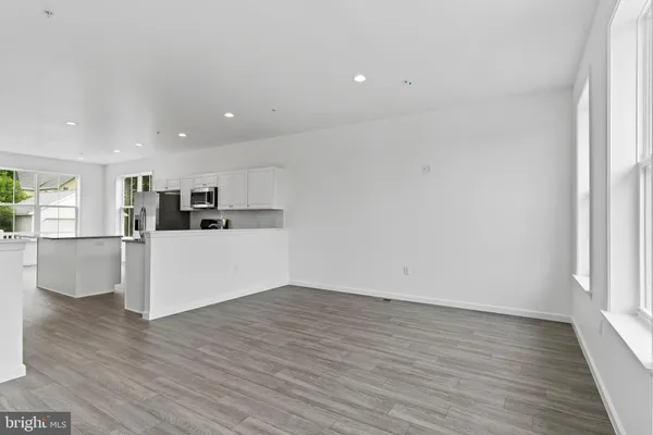 a view of kitchen with wooden floor and electronic appliances
