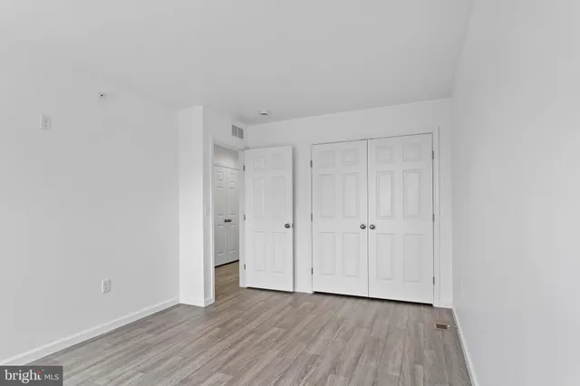 a view of an empty room and wooden floor