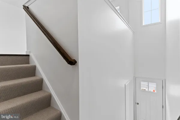 a living room with furniture and stairs