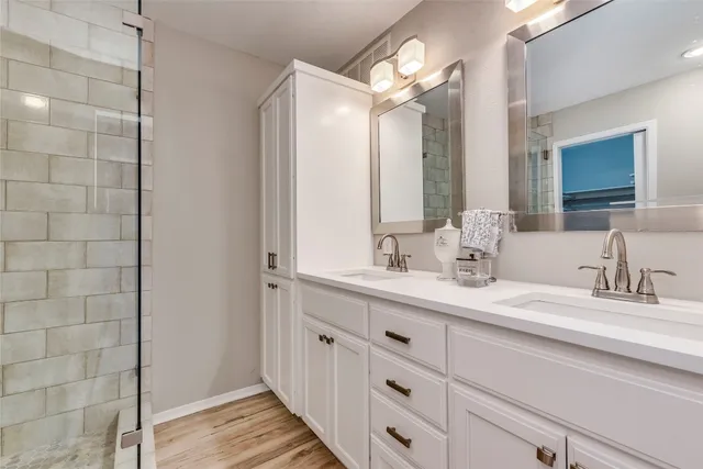 a bathroom with a double vanity sink and a mirror