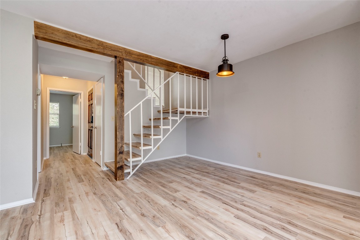 6910 Hart Lane, Unit 805 Austin, TX 78731 - Photo 5 of 17 a view of a hallway with wooden floor and staircase