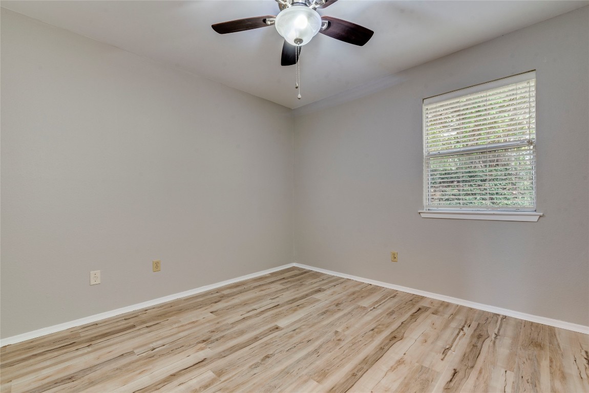 6910 Hart Lane, Unit 805 Austin, TX 78731 - Photo 9 of 17 a view of an empty room with wooden floor and a window