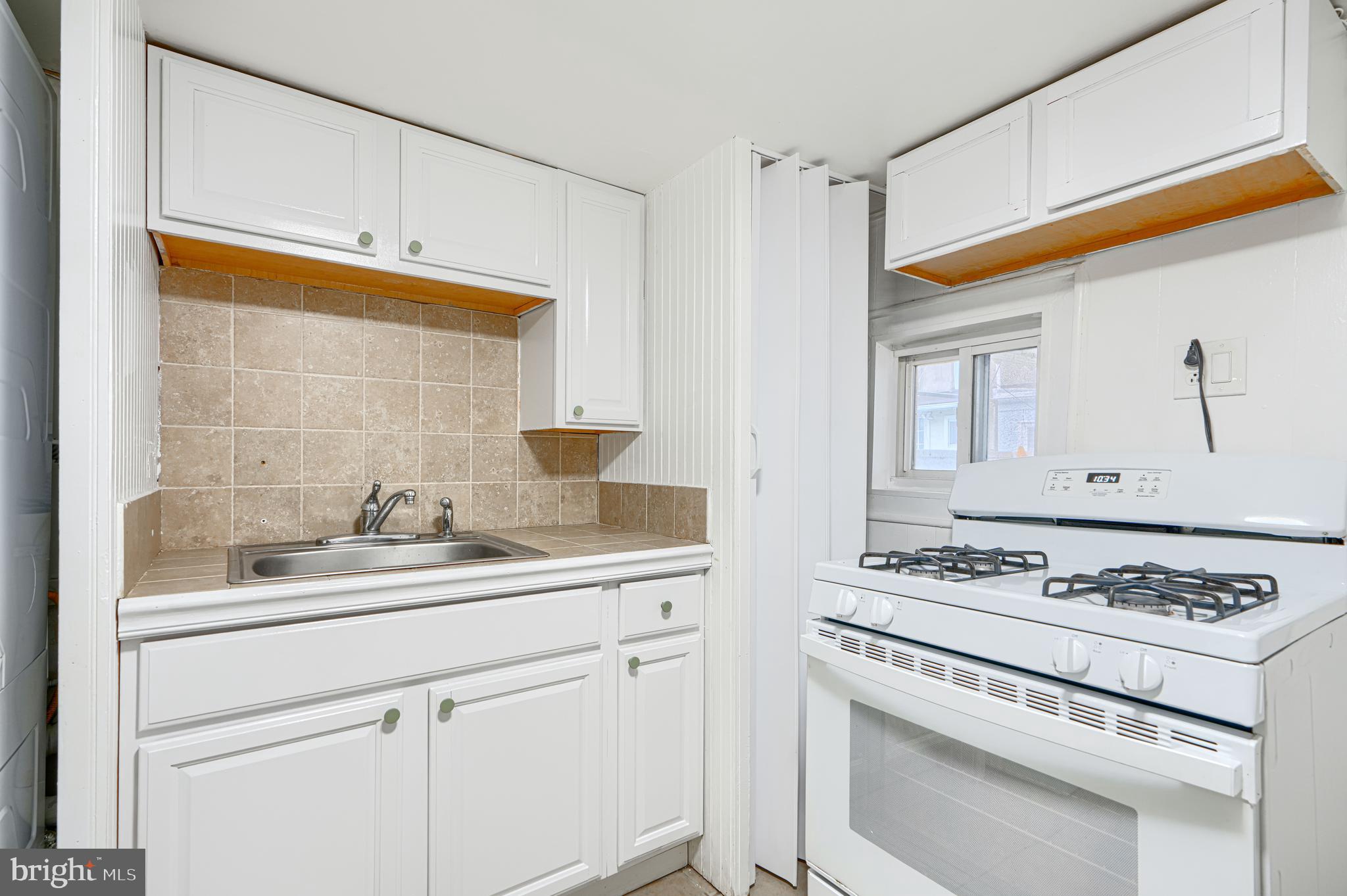 2015 Spark Court Baltimore, MD 21231 - Photo 11 of 12 a kitchen with stainless steel appliances white cabinets and a stove