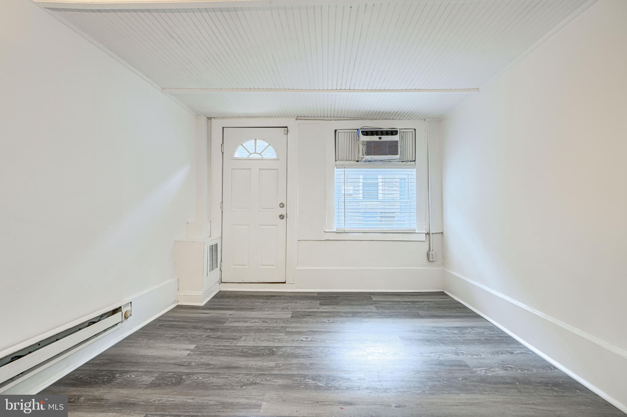 2015 Spark Court Baltimore, MD 21231 - Photo 2 of 12 an empty room with wooden floor and windows