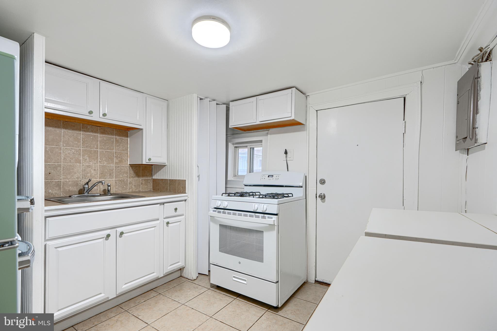 2015 Spark Court Baltimore, MD 21231 - Photo 6 of 12 a kitchen with white cabinets and white appliances