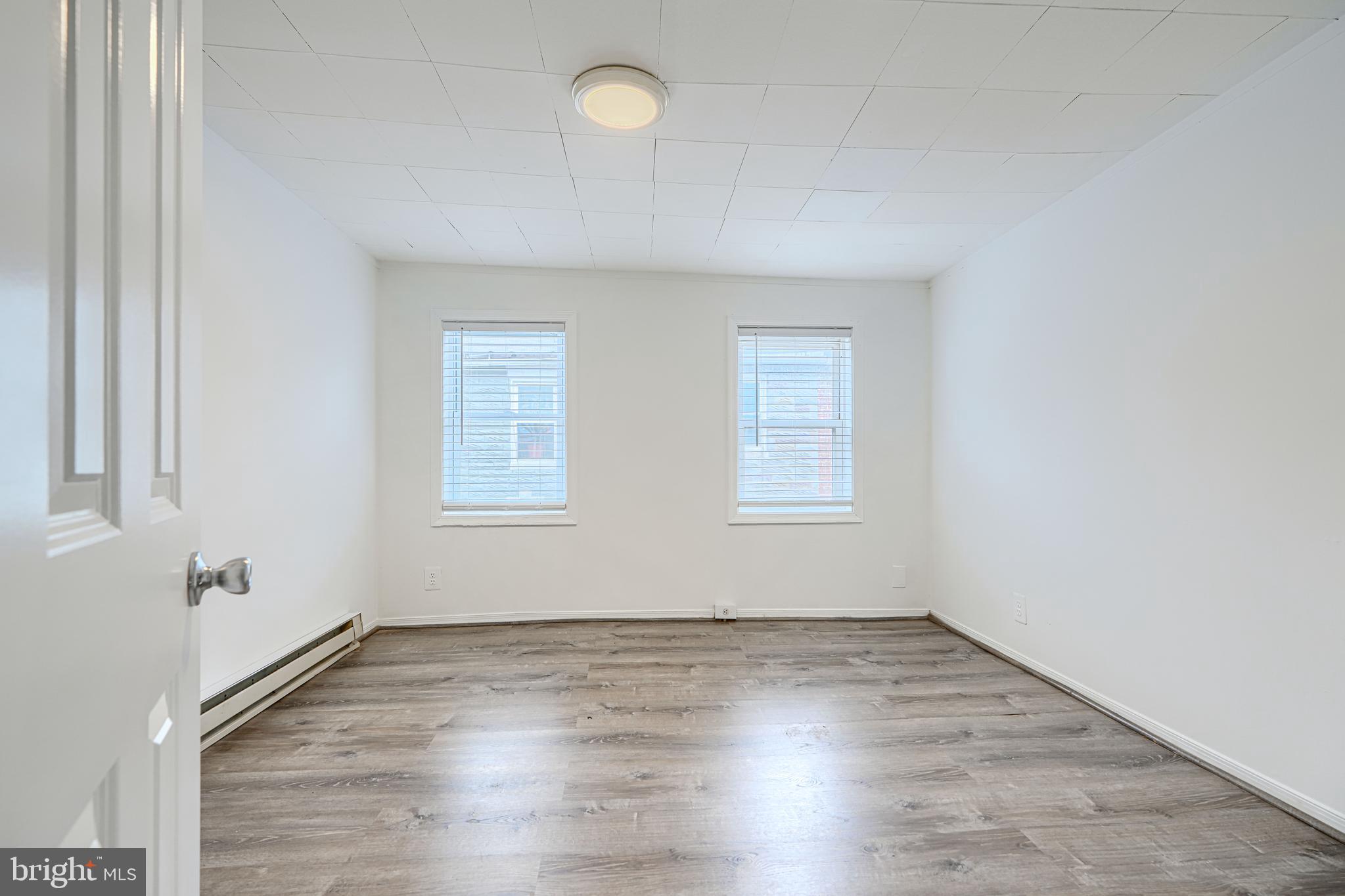 2015 Spark Court Baltimore, MD 21231 - Photo 10 of 12 an empty room with wooden floor and windows