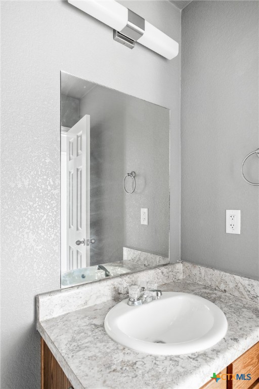 1409 Natchez Trail, Unit A Harker Heights, TX 76548 - Photo 20 of 25 a bathroom with a granite countertop sink and a mirror